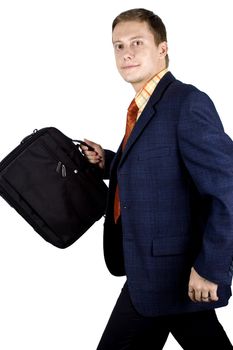 Young, successful and happy businessman walking with briefcase.
