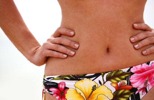 Part of a female body in a bathing suit