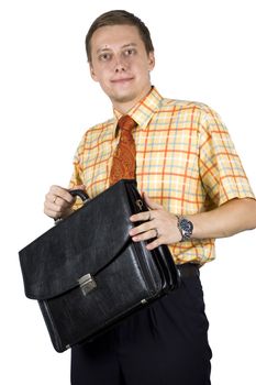 Young, elegant European businessman, wearing suit, shirt and tie. Smiling friendly. Taking brief case for work