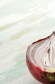 Detail of half of red onion on the table