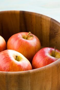 Several red ripe apple on wooden bucket