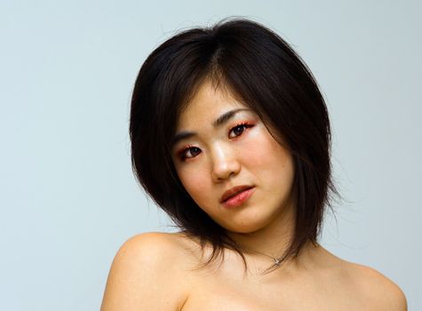 Beautiful sexy Oriental woman with bare shoulders