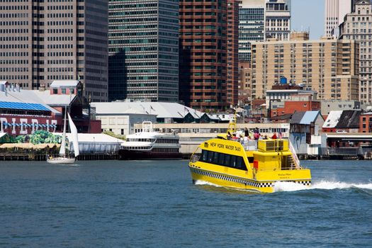 The New York water taxi as an alternative way of transportation here seen going from Brooklyn's Fulton Ferry landing going to South Street sea port in Manhattan's Financial district at Pier 17.
