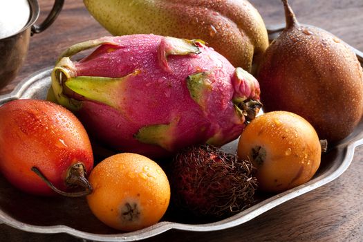 Assortment of exotic fruits, include rambutan, kumquat, tamarillo, pitaya