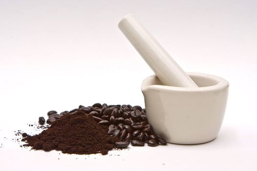 A mortar with freshly roasted gourmet coffee beans and grind isolated on a white background