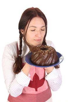 beautiful housewife smelling bundt cake on white background