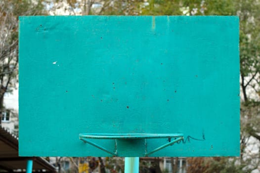 Old metal painted basketball backboard on street playground.