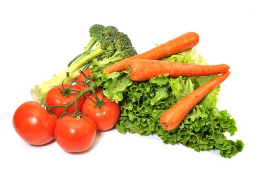 Green leafy lettuce, broccoli, carrots, and tomatoes isolated on white background.