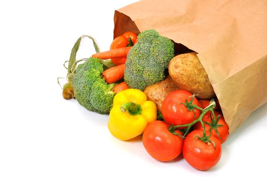 Vegetables in grocery bag isolated on white background.