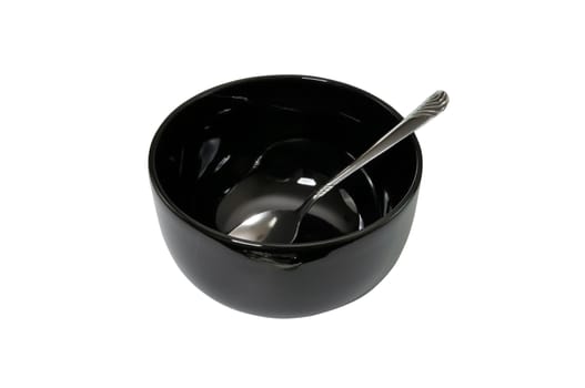 Empty black bowl and spoon isolated on white background with clipping path.