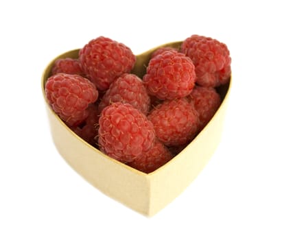 Raspberries in a heart shaped box, isolated on white background.