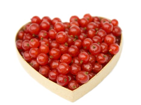 Redcurrants in heart shaped box, isolated on white background.