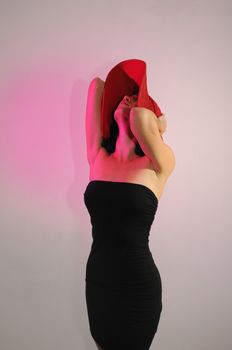 Portrait of young elegant woman wearing black dress and hat