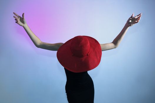 Portrait of young elegant woman wearing black dress and hat