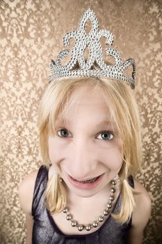 Portrait of pretty young girl with braces wearing a tiara