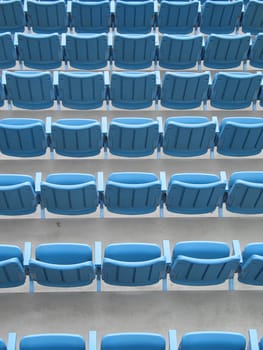blue aligned plastic chairs