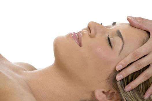 portrait of sleeping female getting head massage