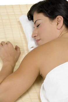 female sleeping on bamboo mat on an isolated background