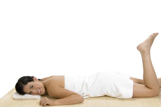 pleased woman laying on bamboo mat