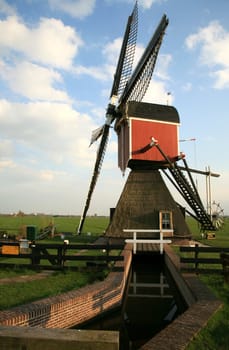 Old pump – traditional Dutch windmill on meadow, Netherlands