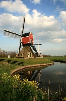 Old pump – traditional Dutch windmill on meadow, Netherlands