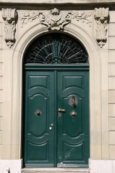 Classic architecture in Bern, Switzerland. Old green wooden door.