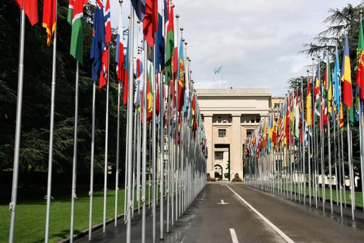 Palace of Nations - seat of the United Nations in Geneva, Switzerland. Flags of all countries.