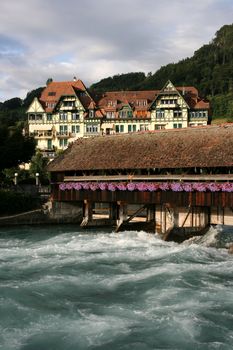 Famous old, wooden sluice bridge in Thun, Switzerland. Aare river.