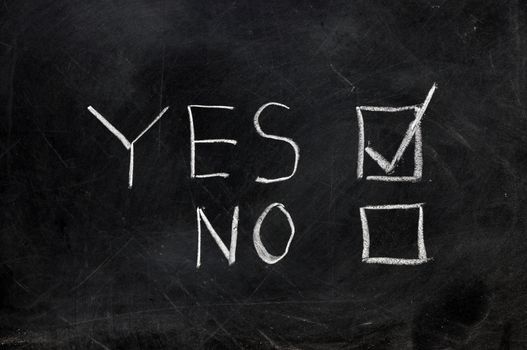 Check yes or no on black chalkboard with copy space.  