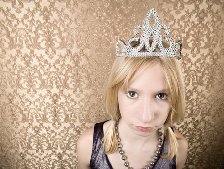 Portrait of pretty pouting young girl wearing a tiara
