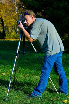 The photographer photographing the nature. Autumn, outdoor