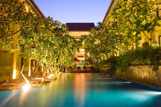 Hotel resort with pool in the middle under magnolia trees