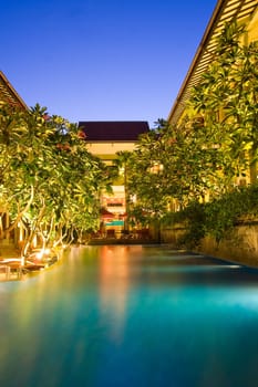 Hotel resort with pool in the middle under magnolia trees