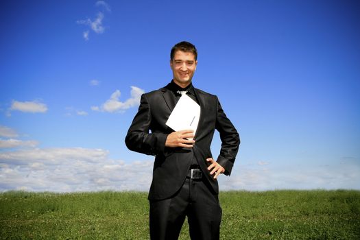 Businessman pulling a folder out his suit.