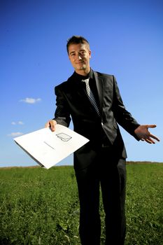 A folder presented to you by a business person in black suit.