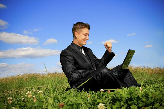 Young businessman outdoor with using laptop.
