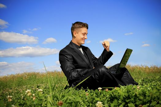 Young businessman outdoor with using laptop.