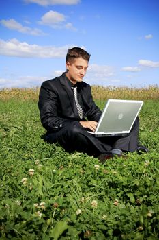 Sitting on the grass and typing