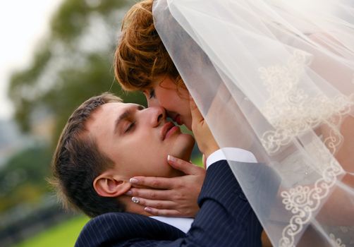 The groom kisses the bride