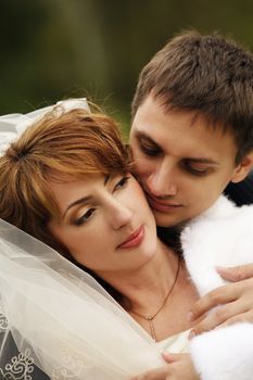 The groom kisses the bride