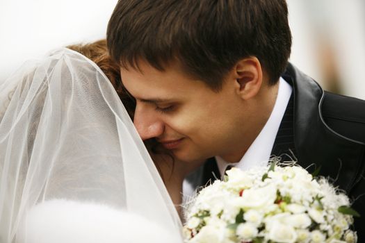 The groom kisses the bride