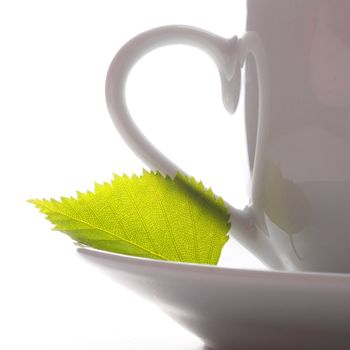 cup of tea or coffee with leaf and white copyspace