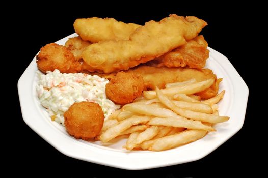 Fish platter with hush puppies, cole slaw, and french fries. Isolated on black background.