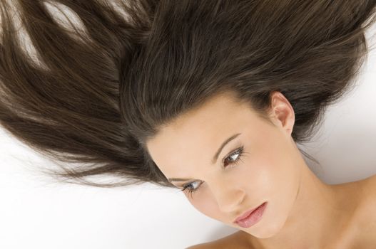 close up on the face of the cute girl laying down with open hair