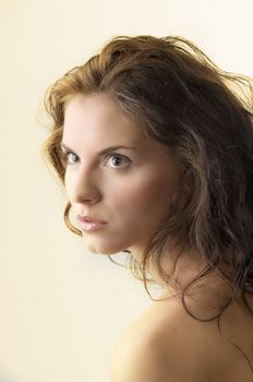 attractive portrait of a cute brunette with moved hair and strong look