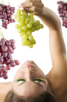 girl with her head down keeping some green grape from top