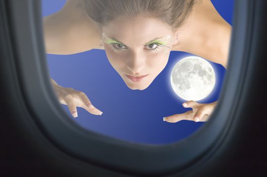 girl flying like a bird in the moonlight sky near an airplane window