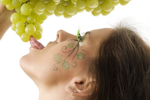 sexy brunette with a nice draw on her face licking green grape