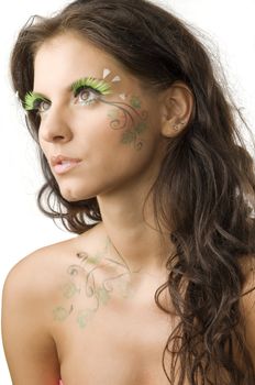 nice and young woman with artificial eyelashes and leaves painted on her