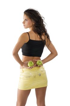 cute young woman with yellow mini skirt and green apple in her hand